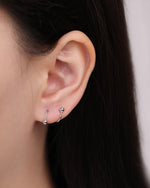 Ball Spiral Screw Back Earring in silver worn on the earlobe, showing the minimalist curved hoop effect and polished ball details.