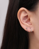 Ball Spiral Screw Back Earring in silver color worn on the opposite ear, showing the mirrored left and right spiral shapes with polished ball ends.