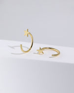 Pair of Star Arc Huggie Hoop Earrings in gold color displayed from different angles, showing the five-point star and S925 open hoop design.