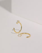 Meissa gold-tone pear-cut clear stone open hoop earrings shown from front and side views.