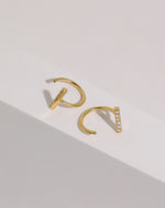 Pair of gold-tone Meissa Sparkling Bar Huggie Hoop Earrings with clear stones shown from front and side angles.