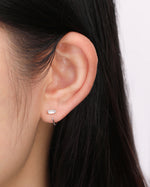 Model wearing silver-tone Meissa Baguette Sparkle Huggie Hoop Earrings in a minimalist ear look.