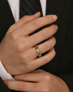 Gold Nova Track Ring in stainless steel styled with formalwear, highlighting the polished grooves and round cubic zirconia center stone.