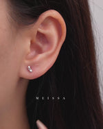 Twist Bar Screw Back Earrings in 925 sterling silver, shown worn on the earlobe and displayed on fingertips to highlight the petite size, polished twist bar design, and minimalist everyday style.